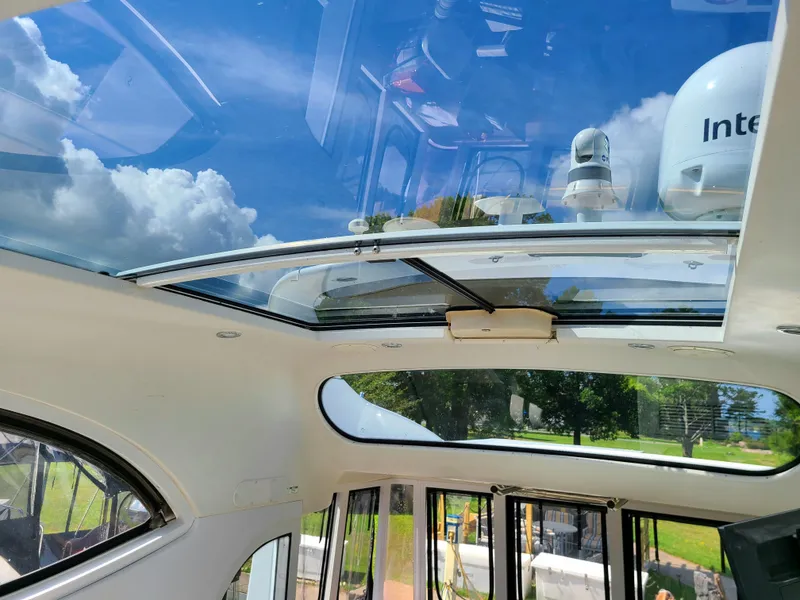 Slide: The Image of Interior view of 2001 Carver 506 Motor Yacht with glass ceiling and blue sky. - 18