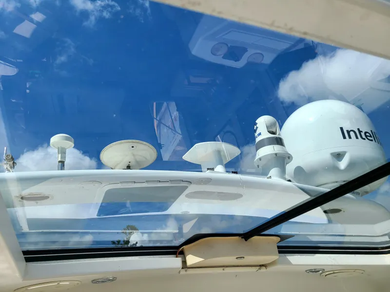 Slide: The Image of 2001 Carver 506 Motor Yacht with radar and satellite equipment against a blue sky. - 19