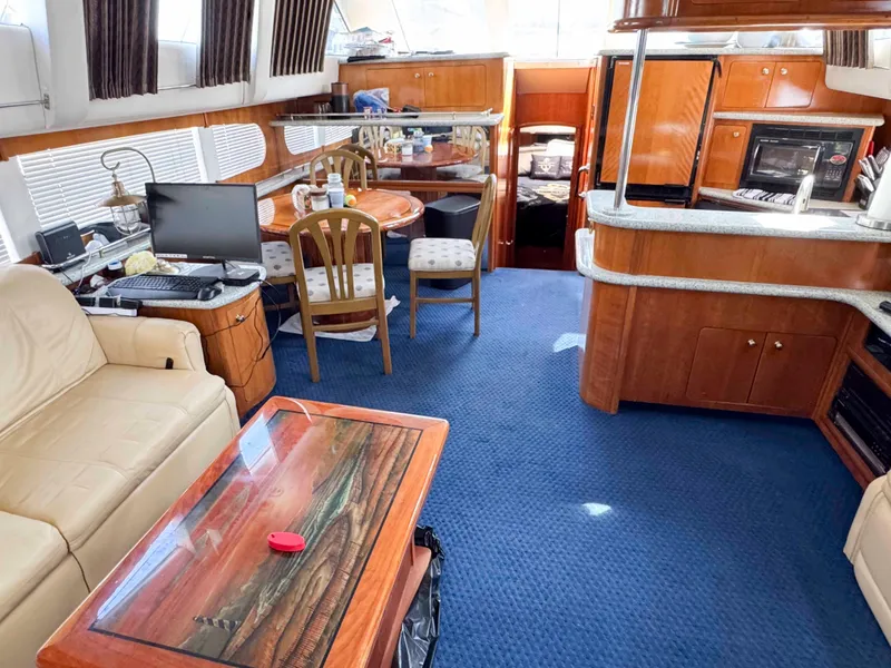 Slide: The Image of Interior of 2001 Carver 506 Motor Yacht with cozy seating and dining area. - 21
