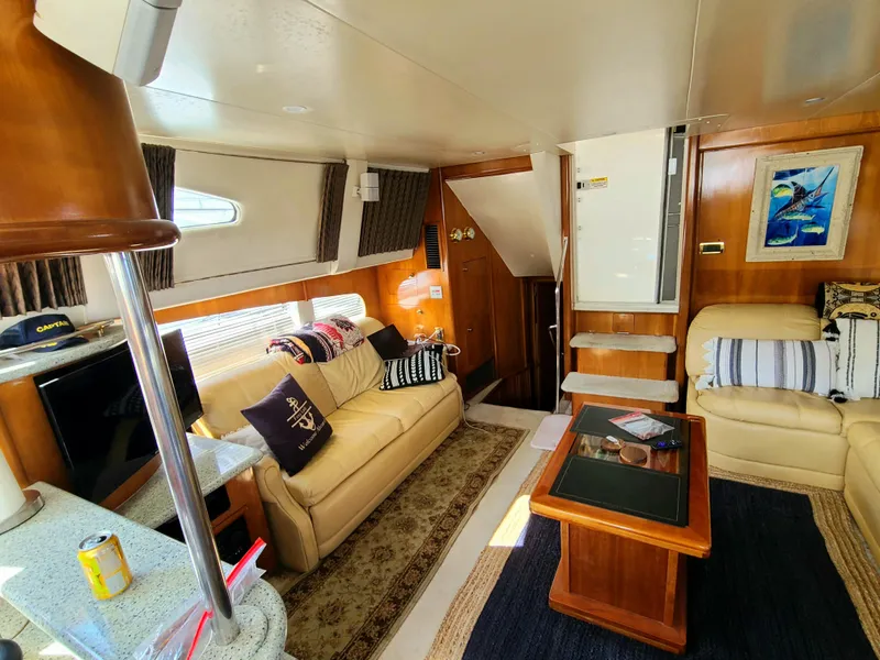 Slide: The Image of Interior of 2001 Carver 506 Motor Yacht with cozy seating and nautical decor. - 23