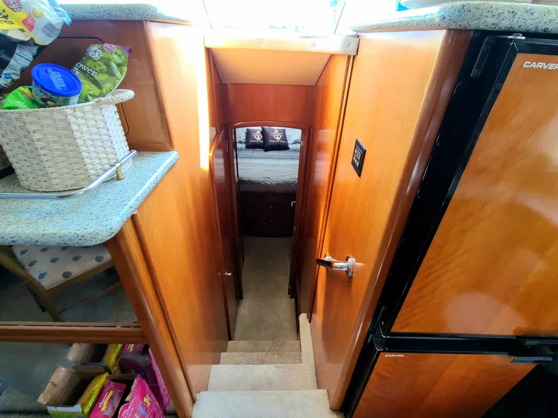 Slide: The Image of 2001 Carver 506 Motor Yacht interior with wooden stairs and modern amenities. - 29