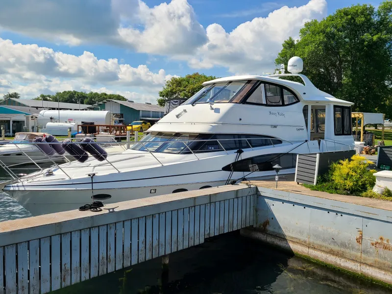 Slide: The Image of 2001 Carver 506 Motor Yacht docked at marina under blue sky. - 3