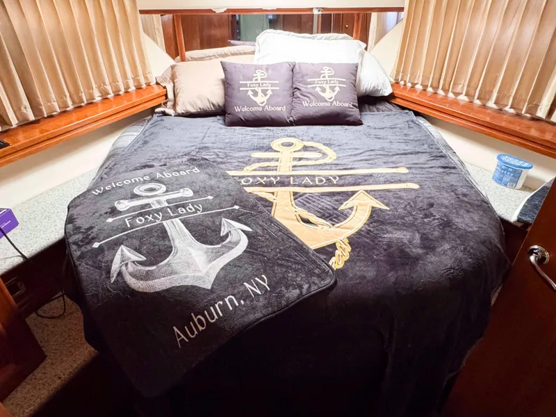 Slide: The Image of Luxurious bedroom in 2001 Carver 506 Motor Yacht with nautical-themed bedding. - 30