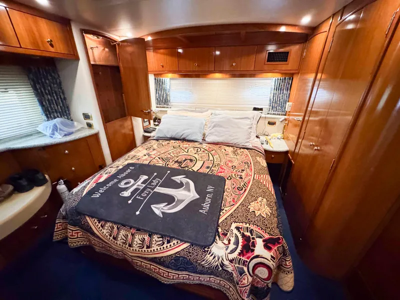 Slide: The Image of Luxurious bedroom interior of 2001 Carver 506 Motor Yacht with elegant wood finishes. - 33