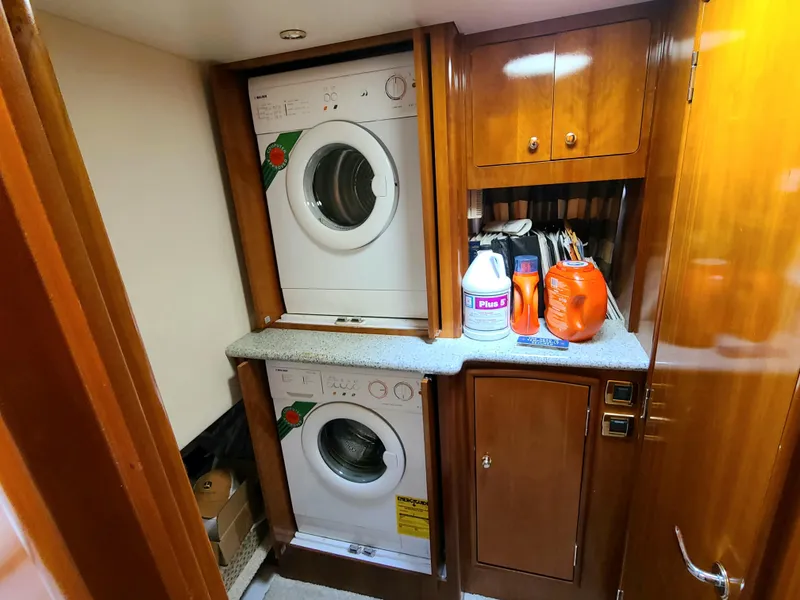 Slide: The Image of Laundry area inside 2001 Carver 506 Motor Yacht with stacked washer and dryer. - 34