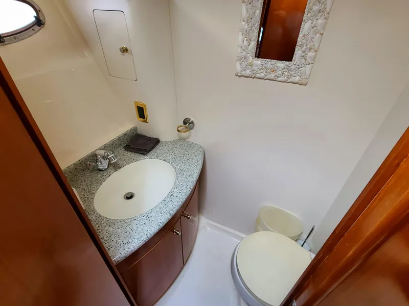 Slide: The Image of 2001 Carver 506 Motor Yacht bathroom with granite countertop and wooden cabinetry. - 35