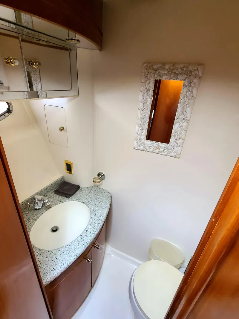 Slide: The Image of 2001 Carver 506 Motor Yacht bathroom with sink, mirror, and storage cabinets. - 36