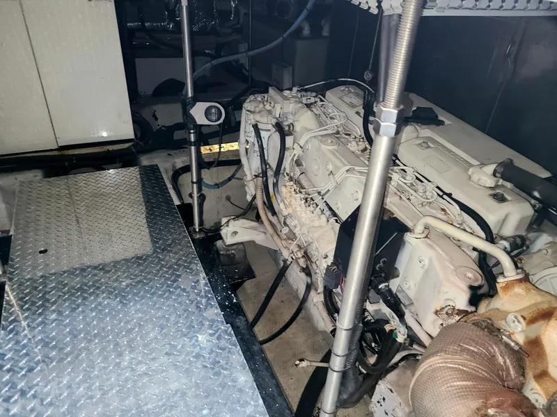 Slide: The Image of Engine room of a 2001 Carver 506 Motor Yacht, featuring mechanical components and metal flooring. - 39