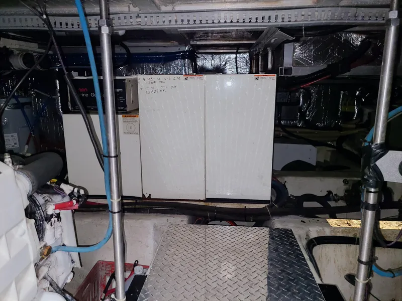 Slide: The Image of Engine room of 2001 Carver 506 Motor Yacht with mechanical equipment and wiring. - 43