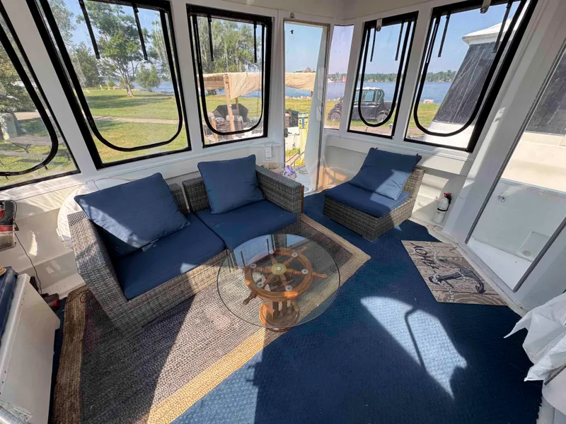 Slide: The Image of Luxurious interior of 2001 Carver 506 Motor Yacht with blue seating and glass table. - 9