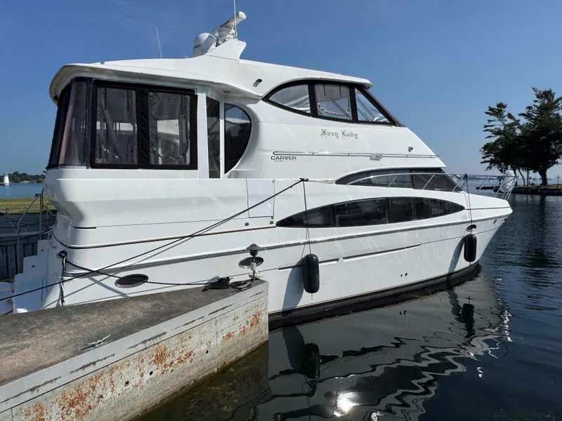 The Image of 2001 Carver 506 Motor Yacht docked at a marina on a sunny day. - 0