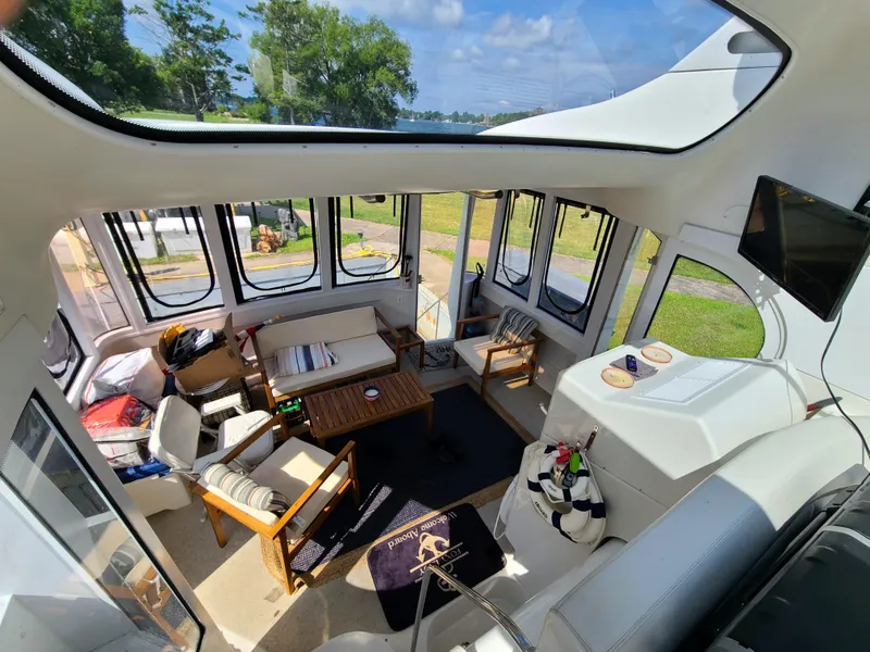 Slide: The Image of Interior of 2001 Carver 506 Motor Yacht with spacious seating and panoramic windows. - 10