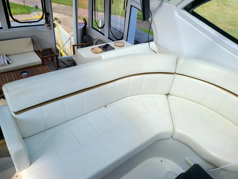 Slide: The Image of 2001 Carver 506 Motor Yacht interior with white leather seating and wooden accents. - 16