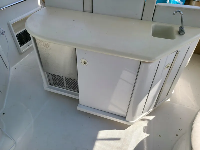 Slide: The Image of 2001 Carver 506 Motor Yacht kitchenette with sink and storage cabinets. - 17