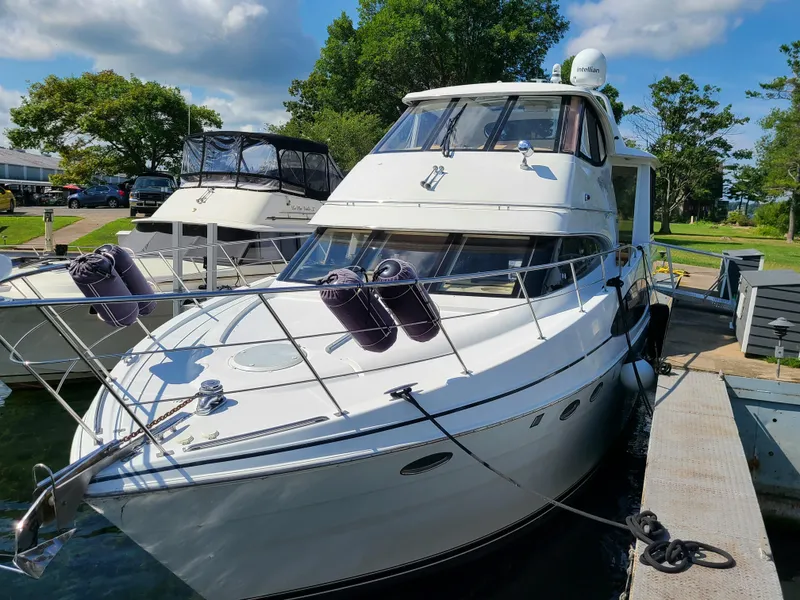 Slide: The Image of 2001 Carver 506 Motor Yacht docked at marina under blue sky. - 6