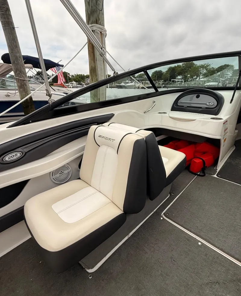 Slide: The Image of 2014 Sea Ray 205 Sport boat interior with seating and dashboard. - 11