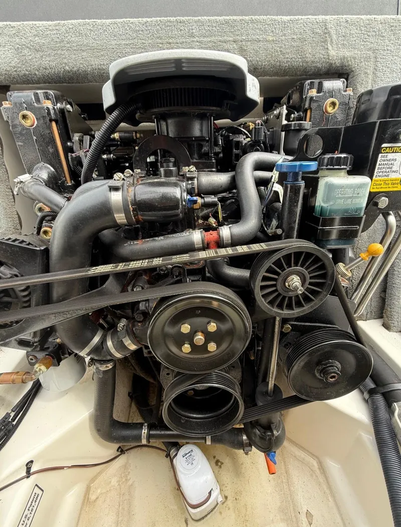 Slide: The Image of 2014 Sea Ray 205 Sport engine, detailed view of components and belts. - 13