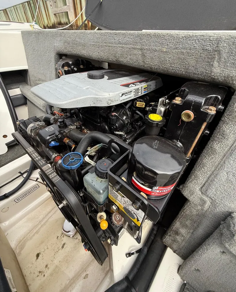 Slide: The Image of Engine compartment of a 2014 Sea Ray 205 Sport boat, showcasing Mercury 4.3L engine. - 14