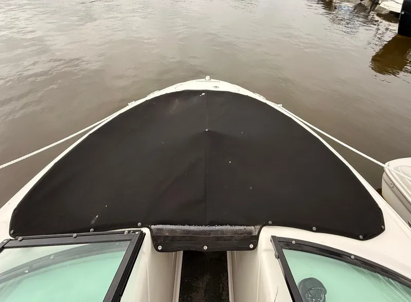 Slide: The Image of 2014 Sea Ray 205 Sport boat with black cover on calm water. - 3