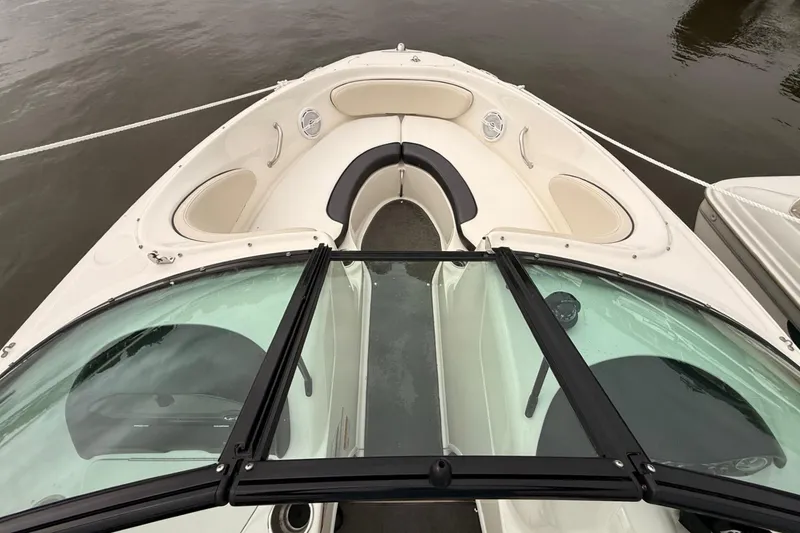 Slide: The Image of 2014 Sea Ray 205 Sport boat with open bow seating on calm water. - 4