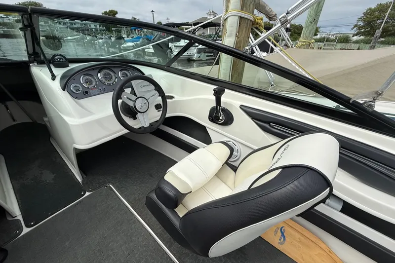Slide: The Image of Interior of a 2014 Sea Ray 205 Sport boat, featuring steering wheel and dashboard controls. - 5