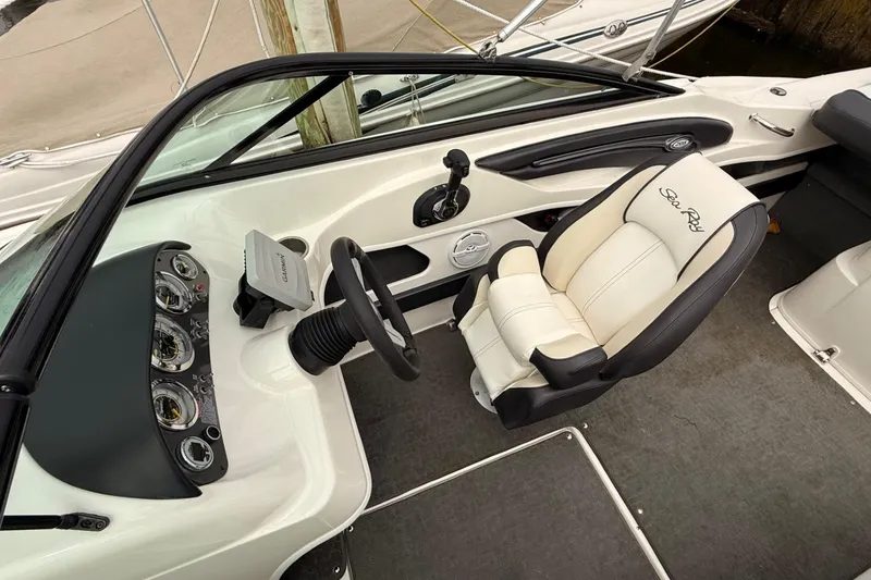 Slide: The Image of 2014 Sea Ray 205 Sport boat interior with steering wheel and dashboard controls. - 6