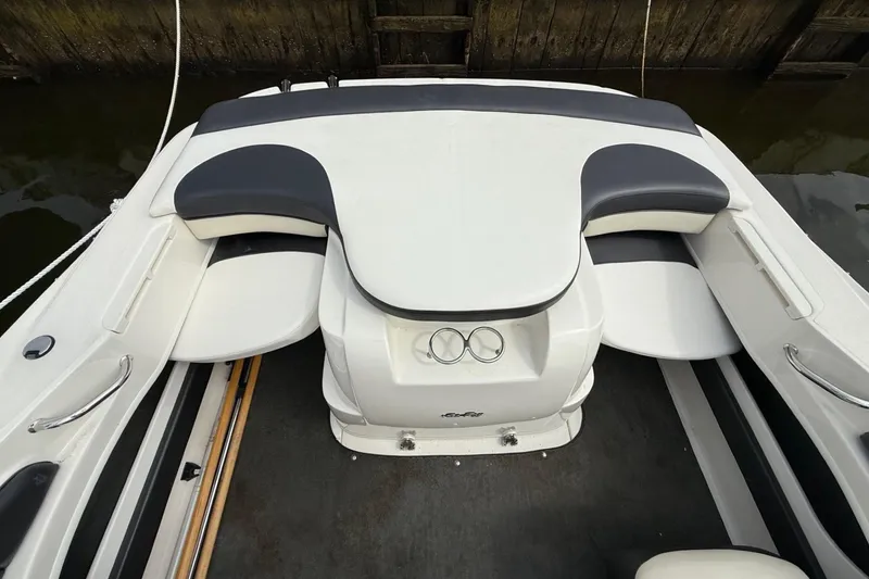 Slide: The Image of 2014 Sea Ray 205 Sport boat interior with cushioned seating and sleek design. - 7