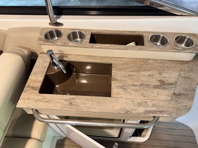 Slide: The Image of 2016 Formula 290 Bowrider boat sink with cup holders and countertop. - 14