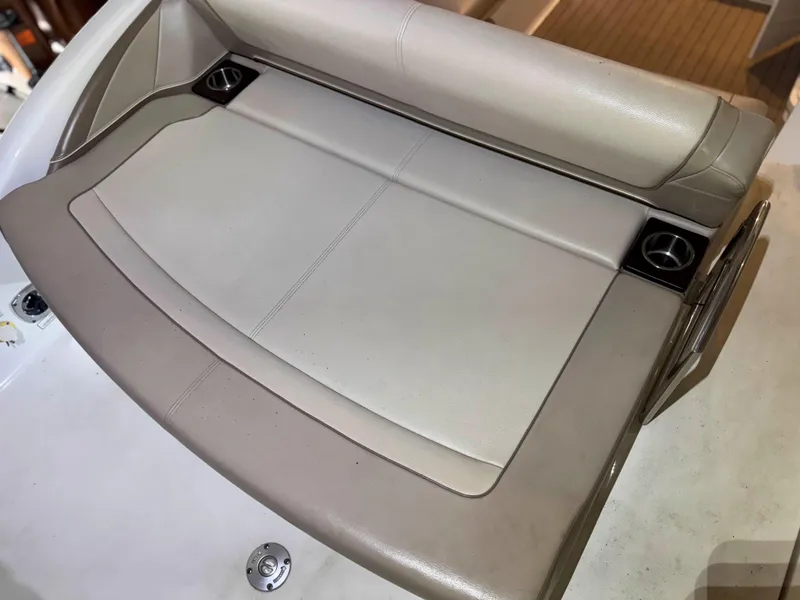 Slide: The Image of 2016 Formula 290 Bowrider boat seating area with cup holders, beige upholstery. - 16