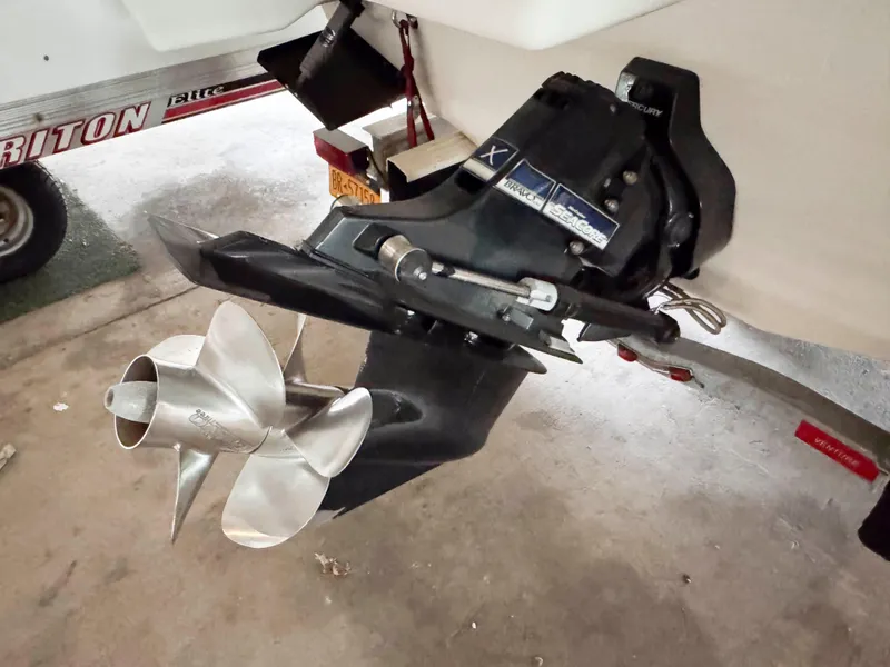 Slide: The Image of 2016 Formula 290 Bowrider boat propeller and outdrive in a garage setting. - 24