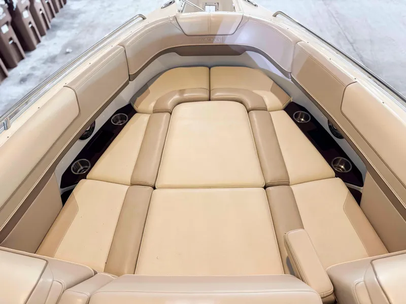 Slide: The Image of 2016 Formula 290 Bowrider interior with beige cushioned seating and cup holders. - 7