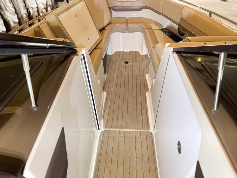 Slide: The Image of 2016 Formula 290 Bowrider interior with beige seating and carpeted flooring. - 9