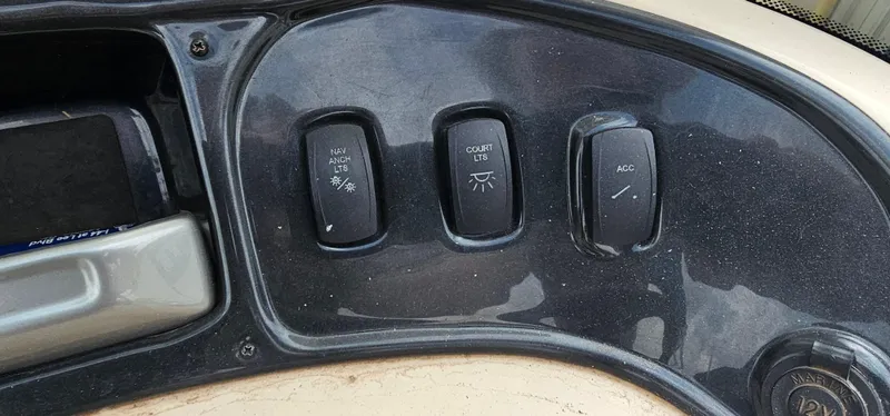 Slide: The Image of Control panel of a 2018 Sun Tracker PB-18 DLX boat with light switches. - 11