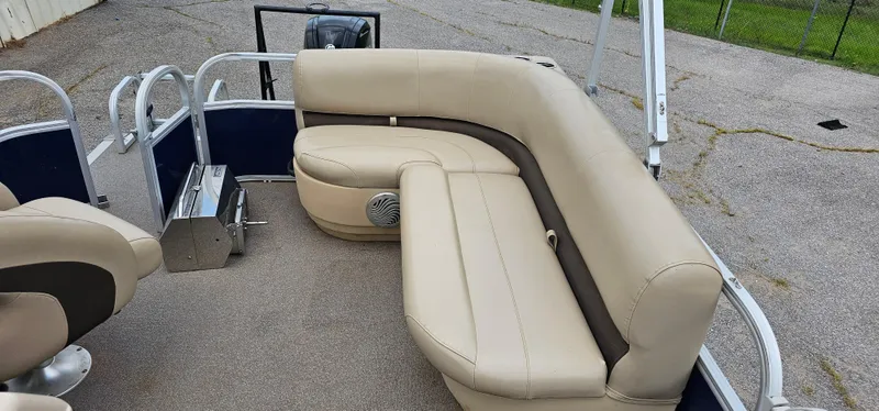 Slide: The Image of 2018 Sun Tracker PB-18 DLX pontoon boat with beige seating and metal railings. - 13