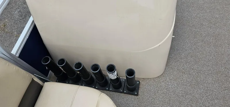 Slide: The Image of 2018 Sun Tracker PB-18 DLX boat interior with rod holders and seating. - 6