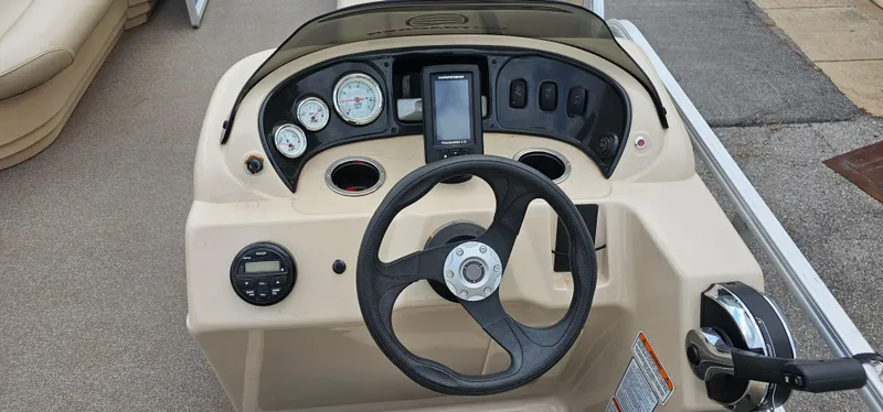 Slide: The Image of Steering console of 2018 Sun Tracker PB-18 DLX boat with gauges and controls. - 8