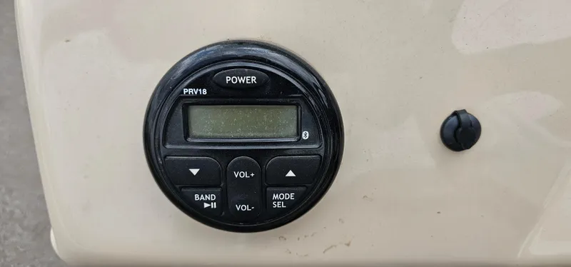Slide: The Image of Control panel of a 2018 Sun Tracker PB-18 DLX boat with power and volume buttons. - 9