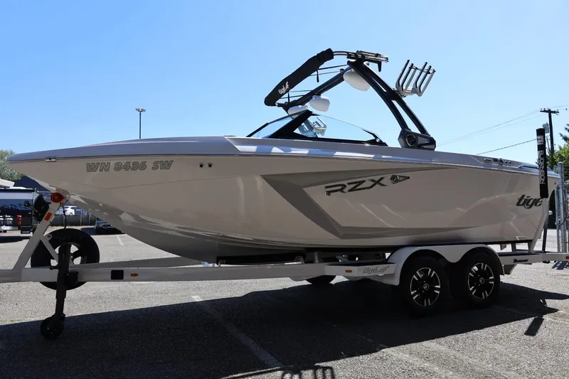 Slide: The Image of 2021 Tigé 22RZX boat on trailer in parking lot, side view. - 10