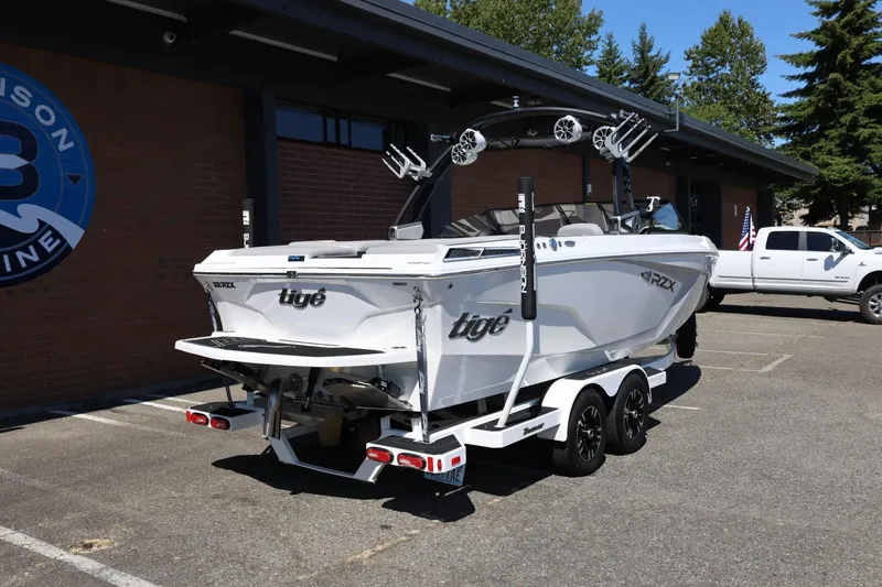 Slide: The Image of 2021 Tigé 22RZX boat on trailer parked outside a building. - 14