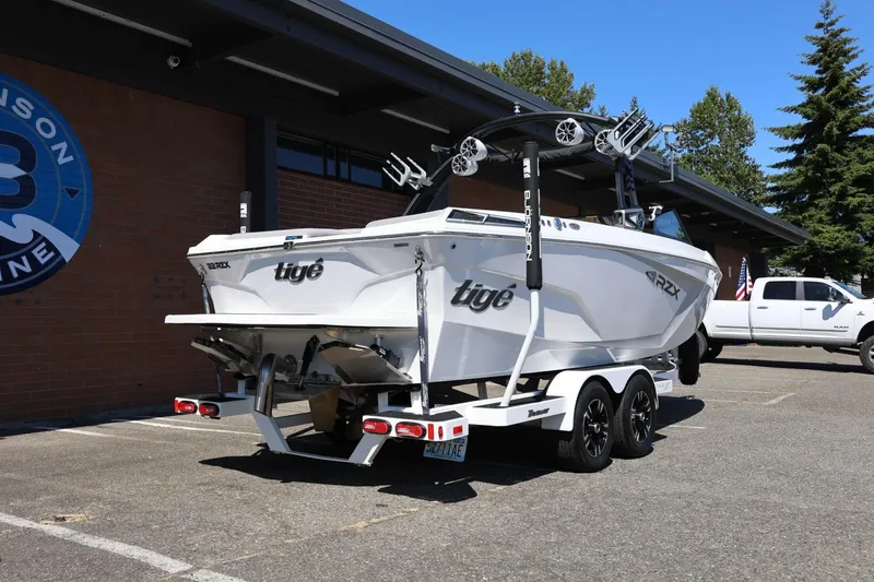 Slide: The Image of 2021 Tigé 22RZX boat on trailer, parked outside a building. - 15