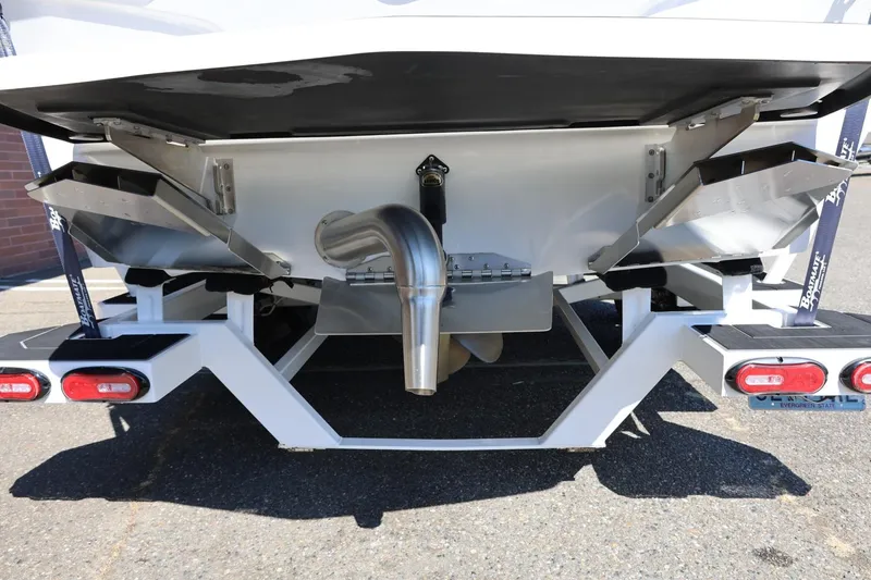 Slide: The Image of Rear view of 2021 Tigé 22RZX boat on trailer, showcasing exhaust and trim tabs. - 16