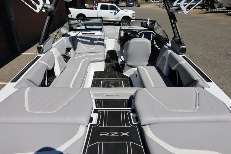 Slide: The Image of 2021 Tigé 22RZX boat interior with sleek gray seating and modern dashboard design. - 20