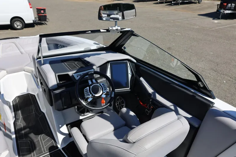 Slide: The Image of 2021 Tigé 22RZX boat interior with modern dashboard and steering wheel. - 26