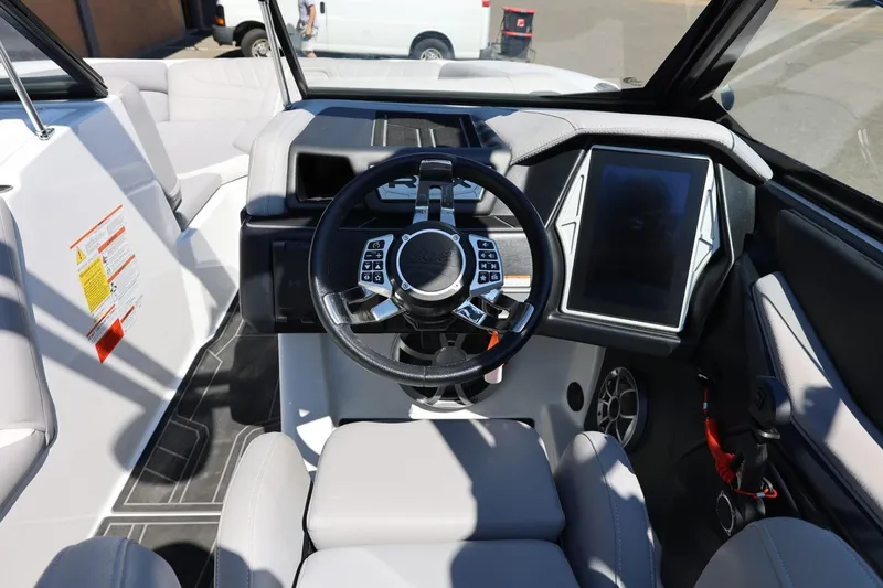 Slide: The Image of 2021 Tigé 22RZX boat interior with steering wheel and touchscreen display. - 27