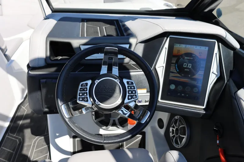 Slide: The Image of 2021 Tigé 22RZX boat dashboard with touchscreen and steering wheel controls. - 28