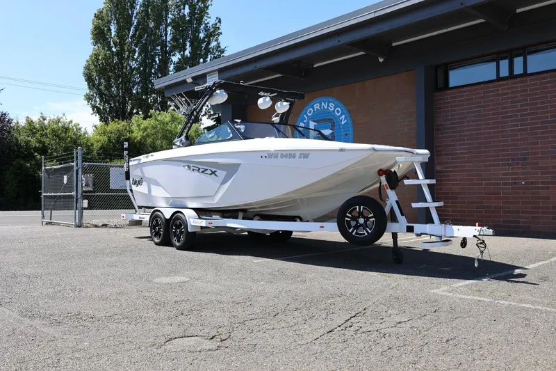 Slide: The Image of 2021 Tigé 22RZX boat on trailer parked outside a building. - 3