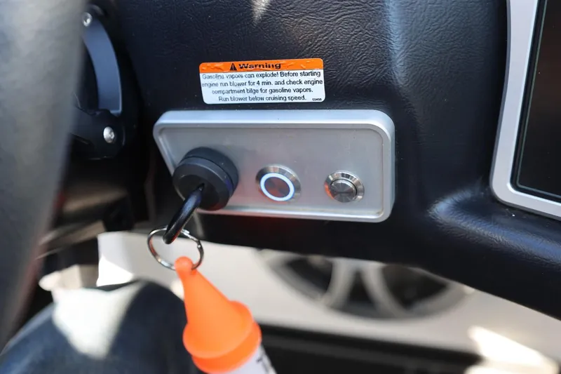 Slide: The Image of 2021 Tigé 22RZX ignition switch with key and warning label. - 35