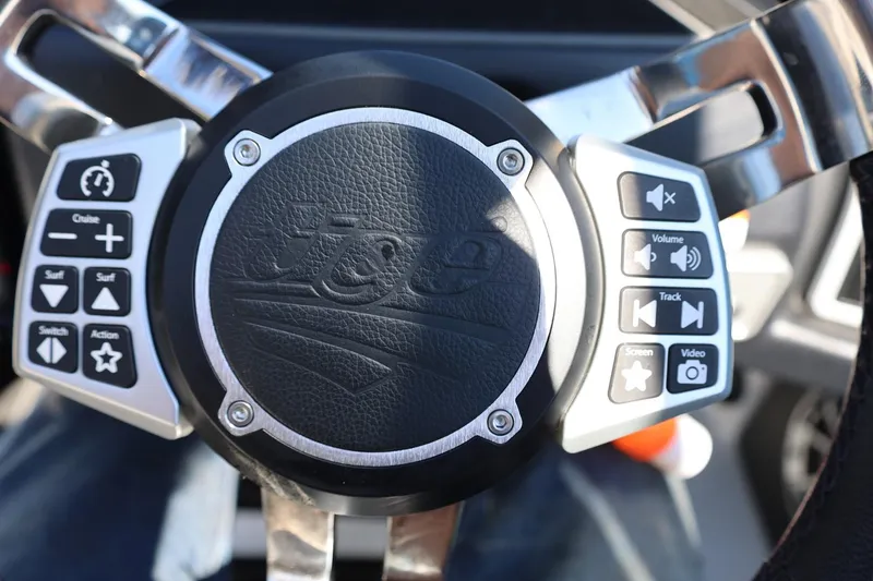 Slide: The Image of Steering wheel of 2021 Tigé 22RZX boat with control buttons. - 36