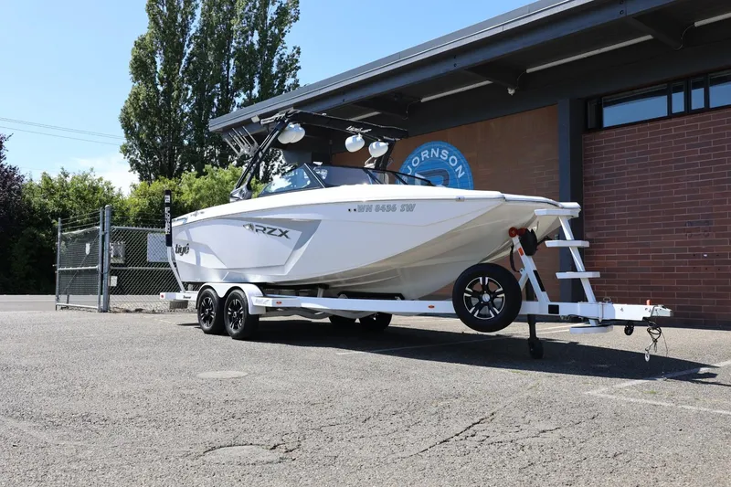 Slide: The Image of 2021 Tigé 22RZX boat on trailer parked outside a building. - 4