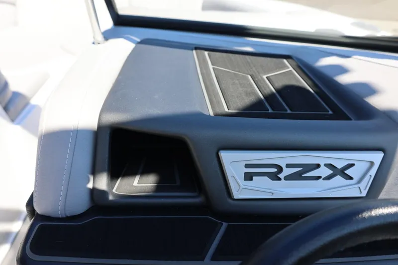 Slide: The Image of 2021 Tigé 22RZX boat dashboard with RZX emblem, featuring sleek design elements. - 46